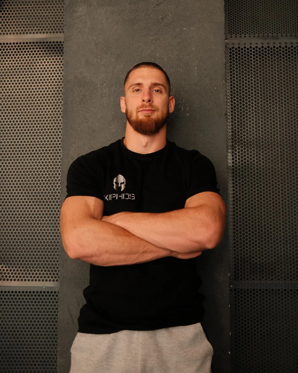 Luka, Xiphos Pro coach, standing with his arms crossed